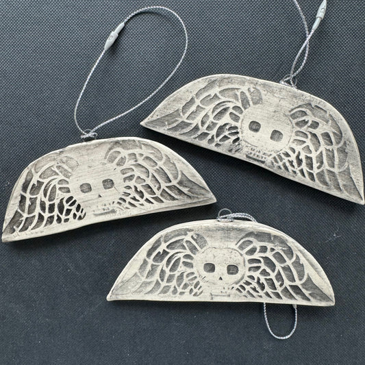 Handmade ceramic winged death's head ornament