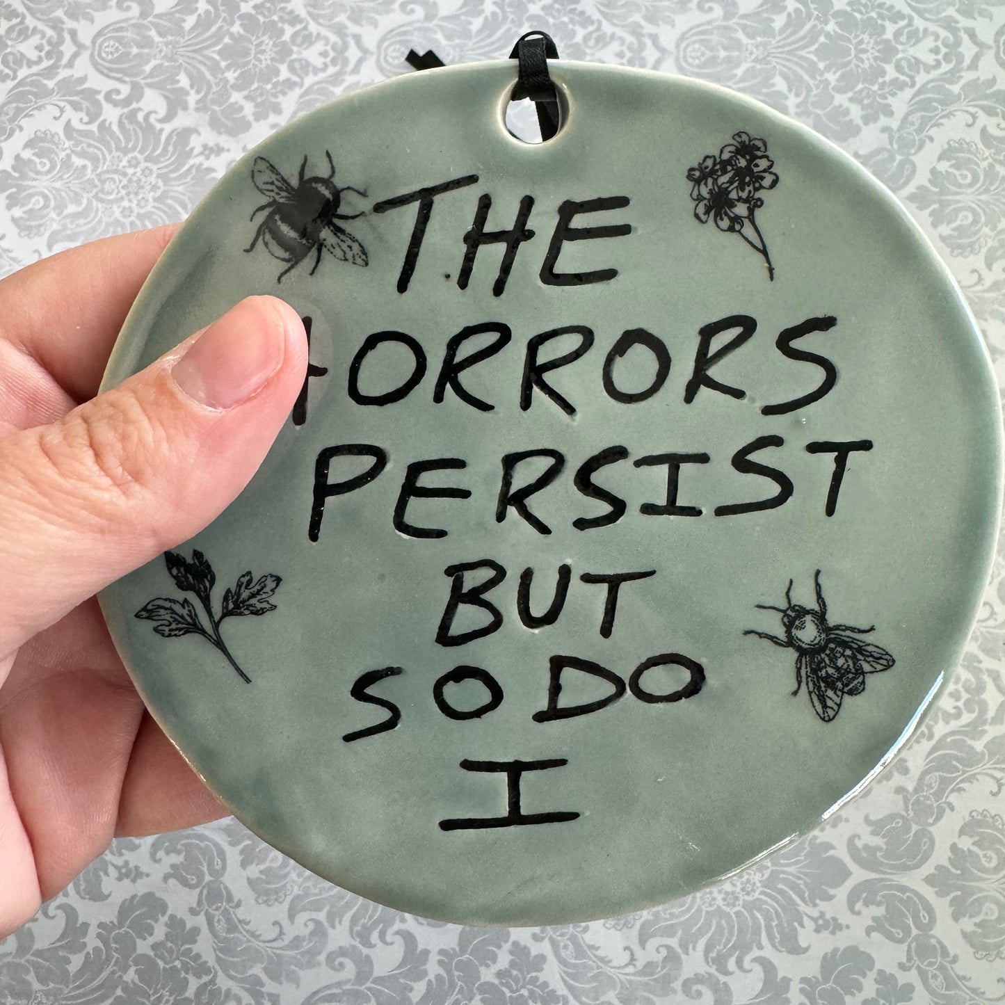 Handmade ceramic The Horrors Persist But So Do I wall hanging in blue grey