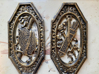 Pair of vintage 70s Homco Spanish gothic wall plaques. Retro resin plastic medieval shield wall hangings. Black and gold goth home decor.