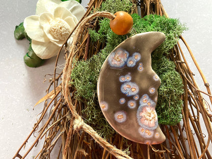 Handmade ceramic moon ornament.